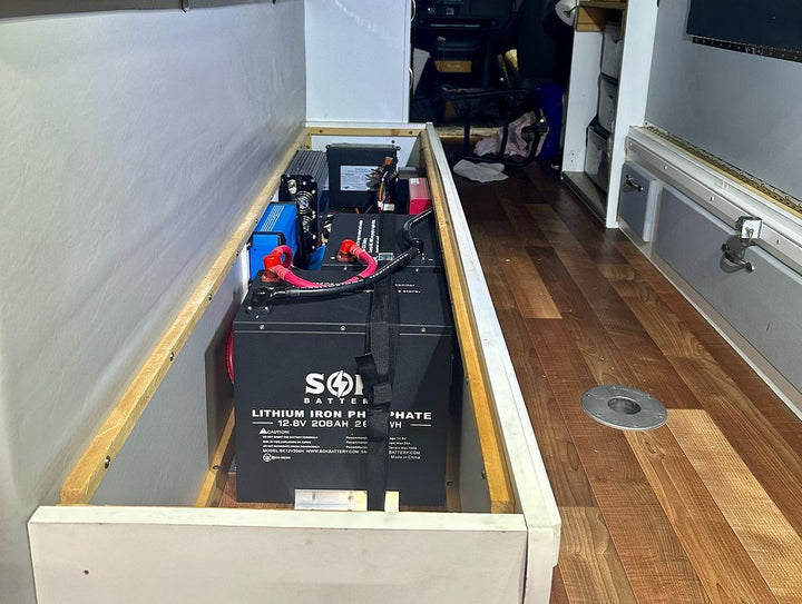 SOK 12.8V 206Ah LiFePO4 battery installed in a custom RV electrical compartment.